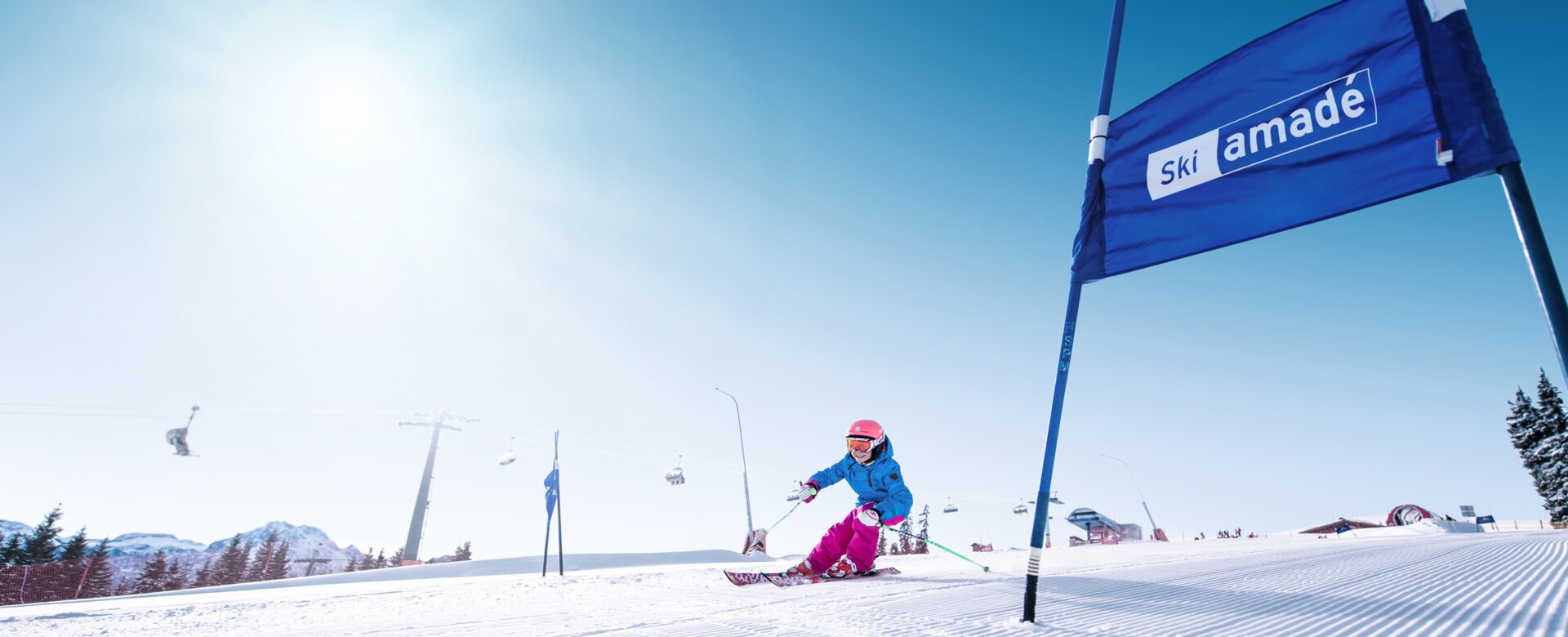 Child skis into the bend so that it can pass the blue gate